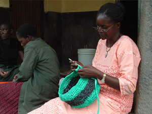 Margaret works a recycled bag with crochet